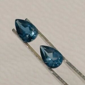 A pair of teardrop, London, blue topaz gemstones